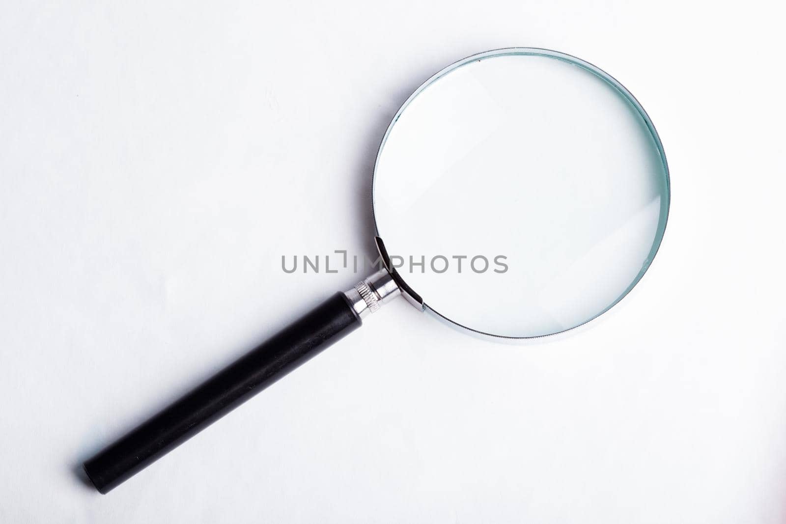 Glass magnifier closeup on a blue background