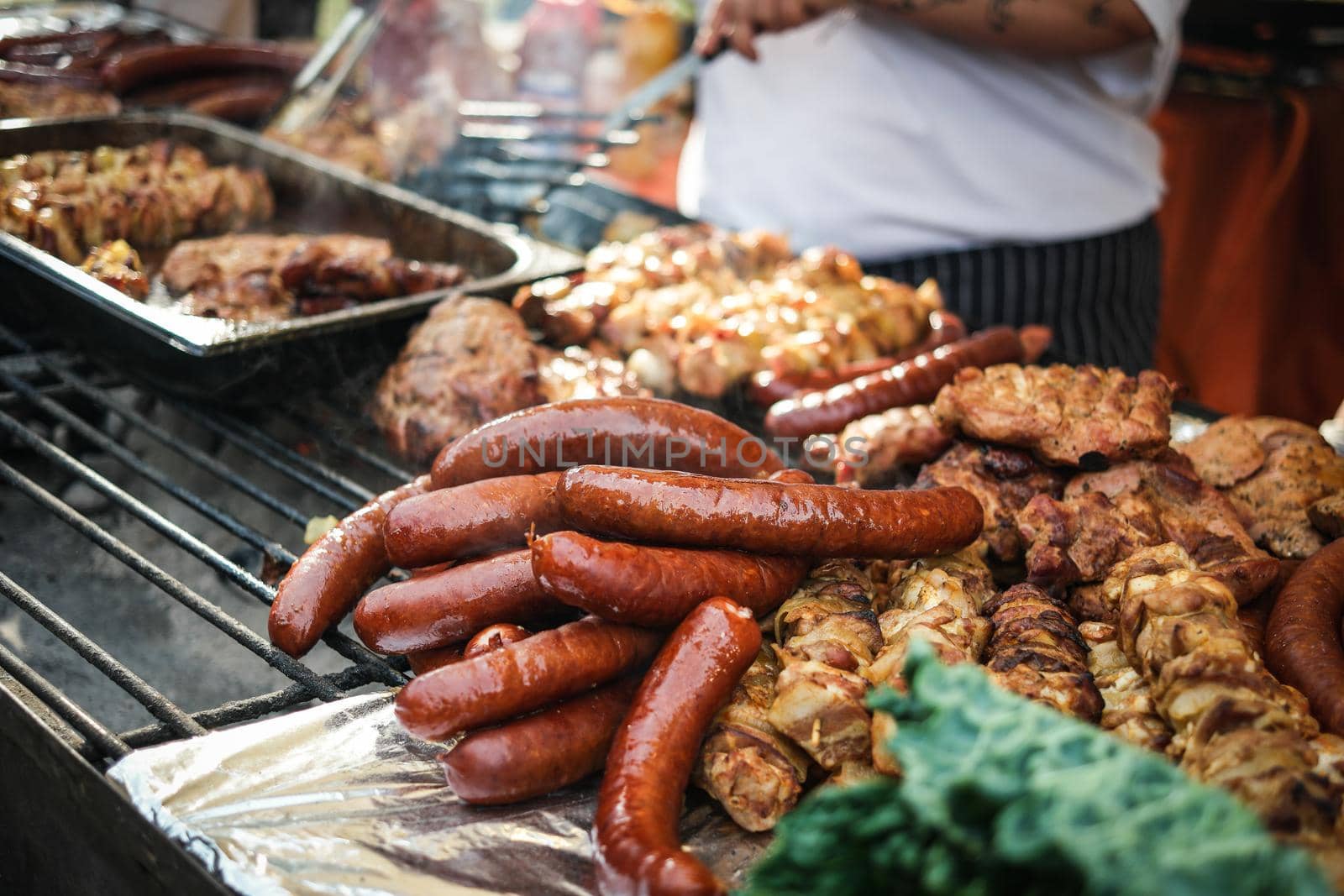 sausages and meat cooking on fire