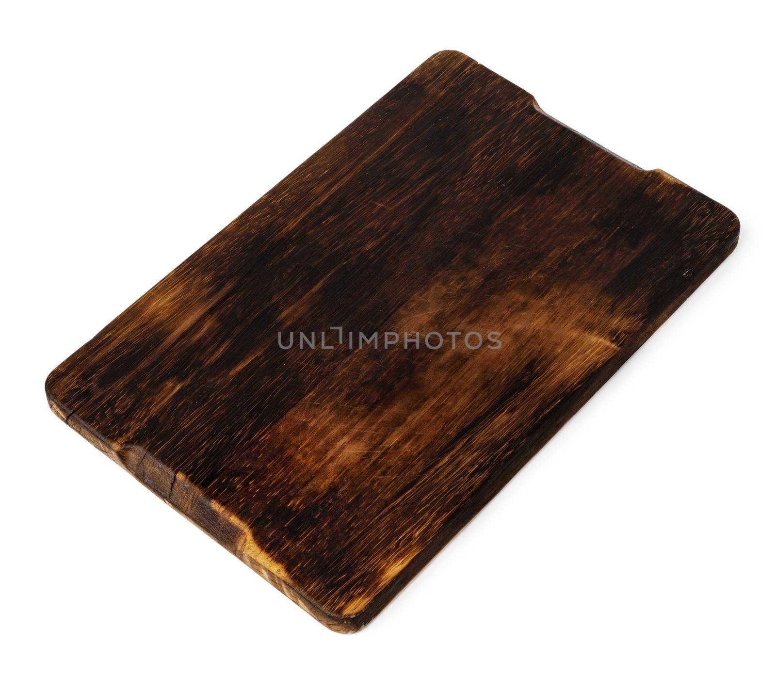 Dark wooden cutting board on white background, close up