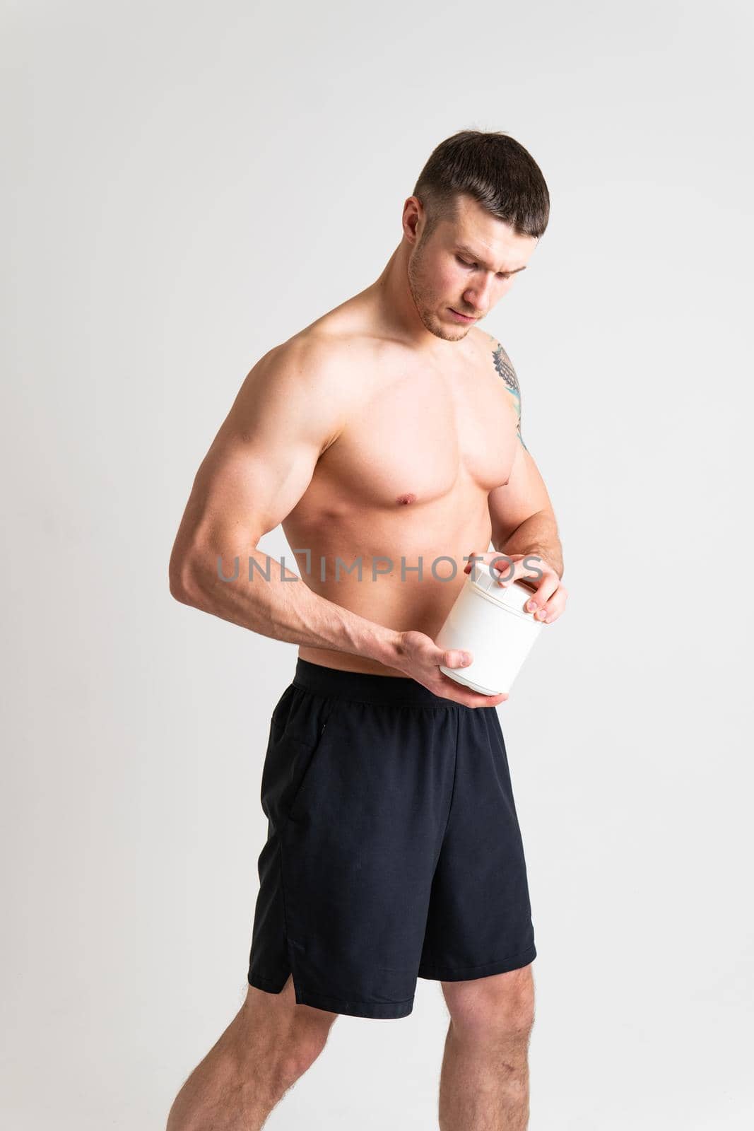 Fitness protein jars white on white background bodybuilder powder strong high pain muscle, cramp person male health medical, illness holding. Touching neck therapy, back suffer attractive