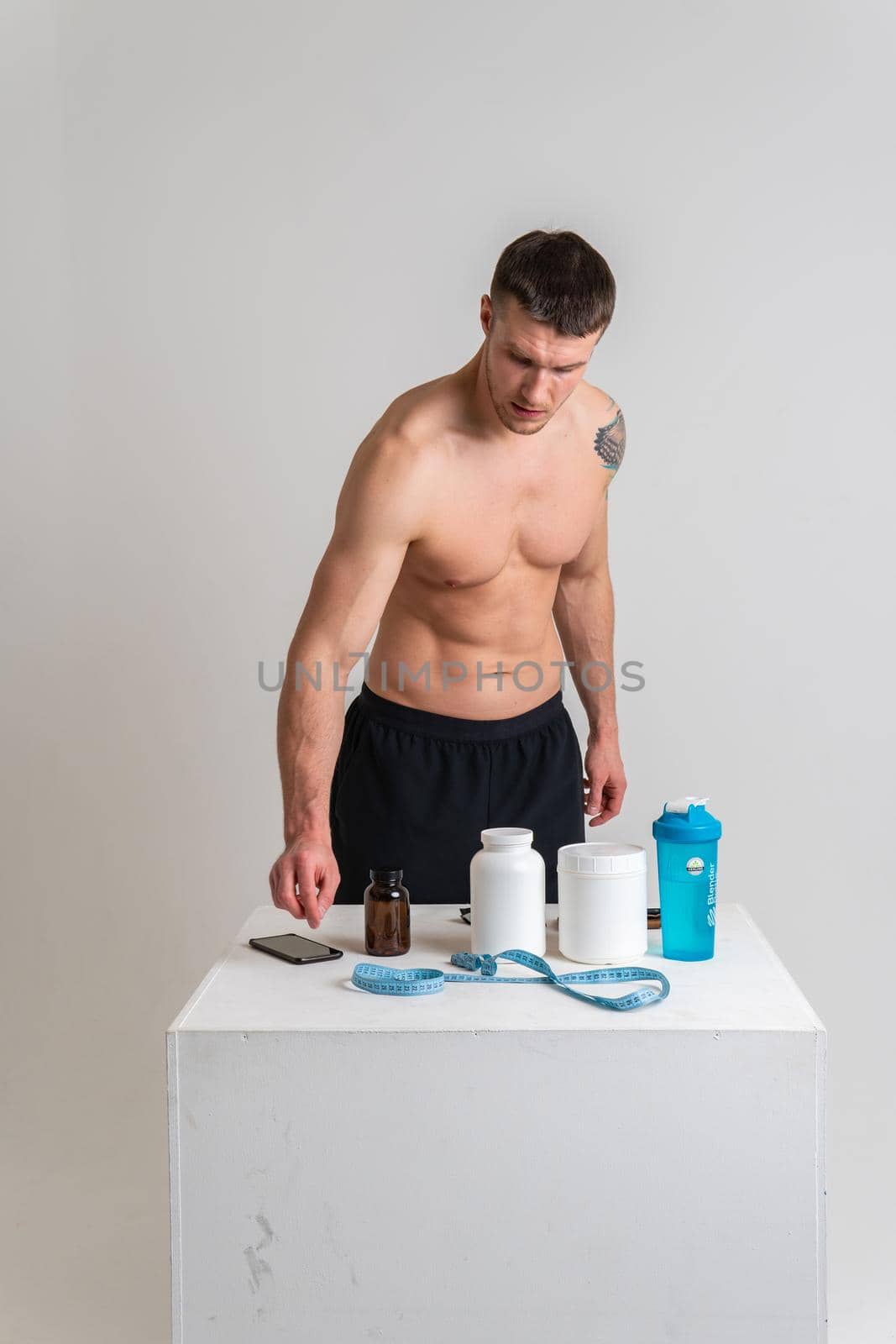 Fitness protein jars white on white background bodybuilder powder strong high back person massage medicine, muscular expression. Hold lumbar ain suffer attractive by 89167702191