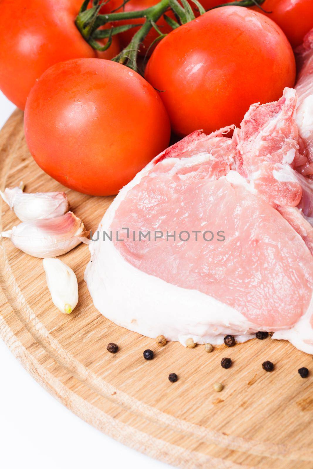 Raw loin slices on the board isolated on white