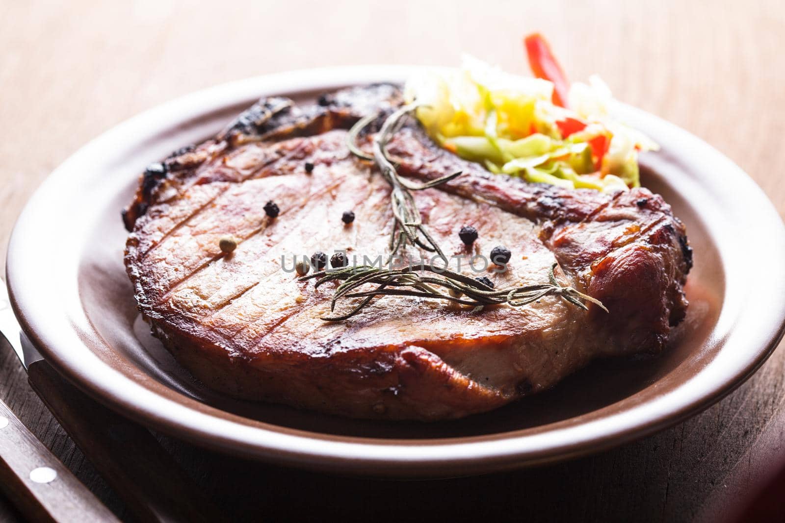 Meat steak roasted on grill with spices on the plate