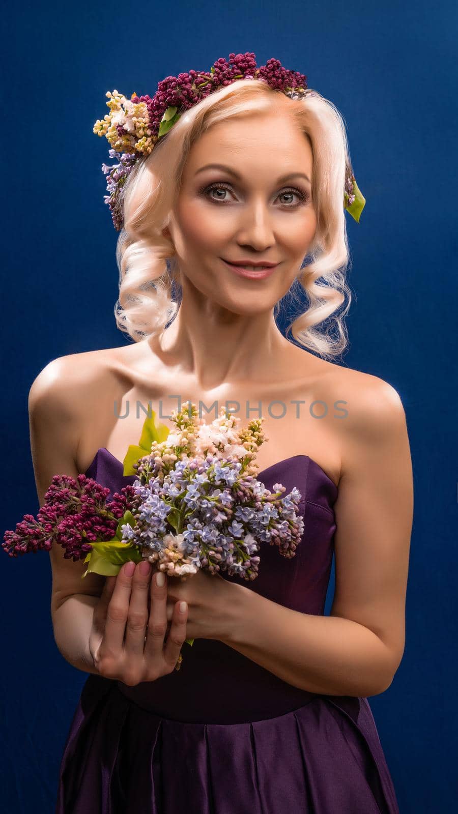 A prosperous young wonderful in a lilac wreath with delicate lips blooms, with bright daylight by 89167702191