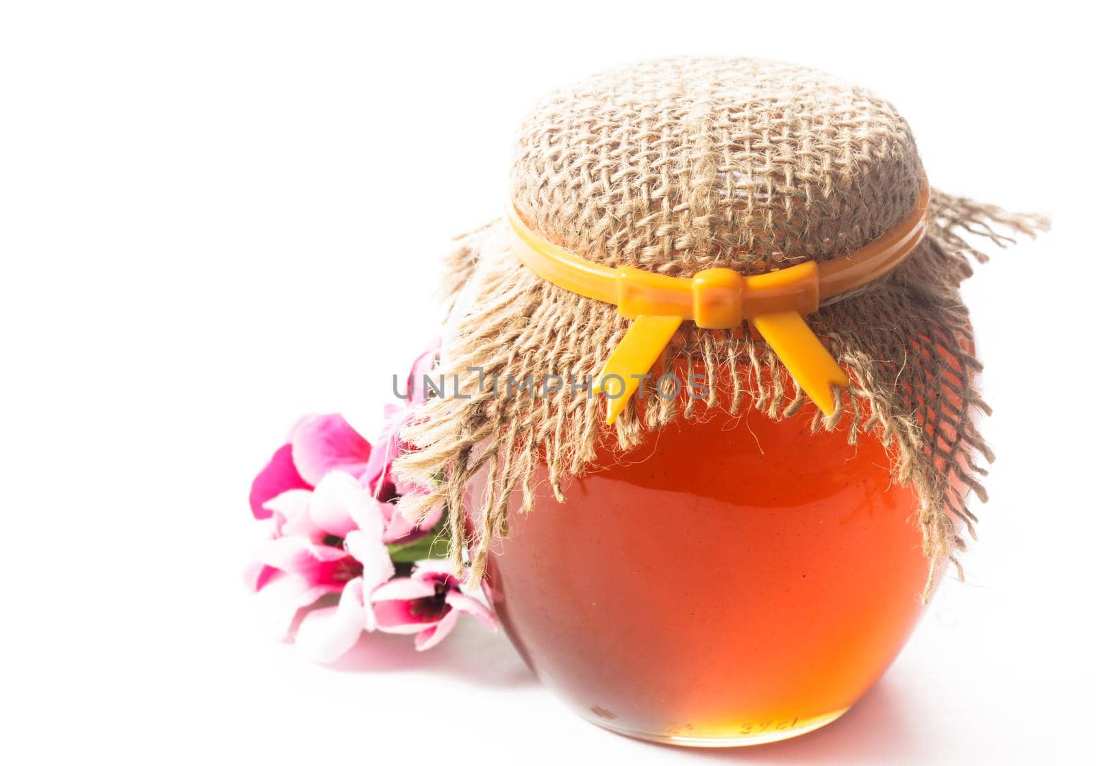 Jam or honey in a jar on white backround