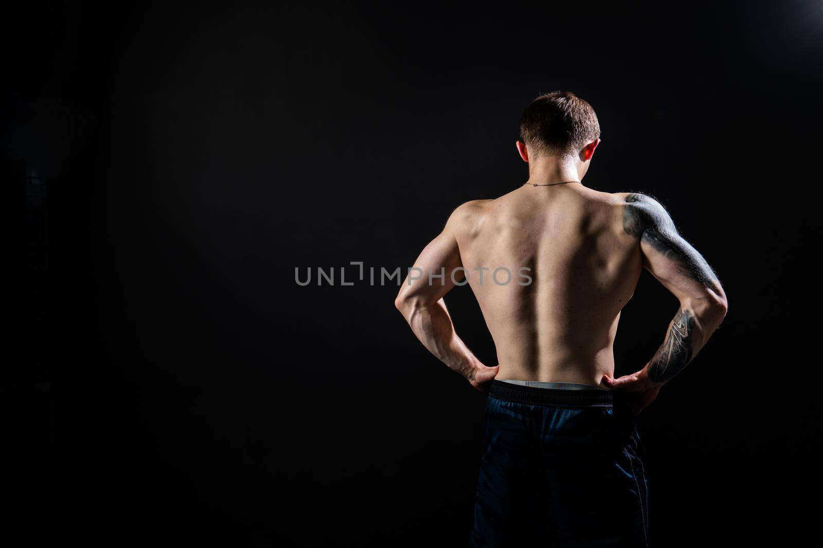 Man on black background keeps dumbbells pumped up in fitness active chest athlete muscular strong athletic hand, male pectoral. handsome power, gym fit back of the arm muscles by 89167702191