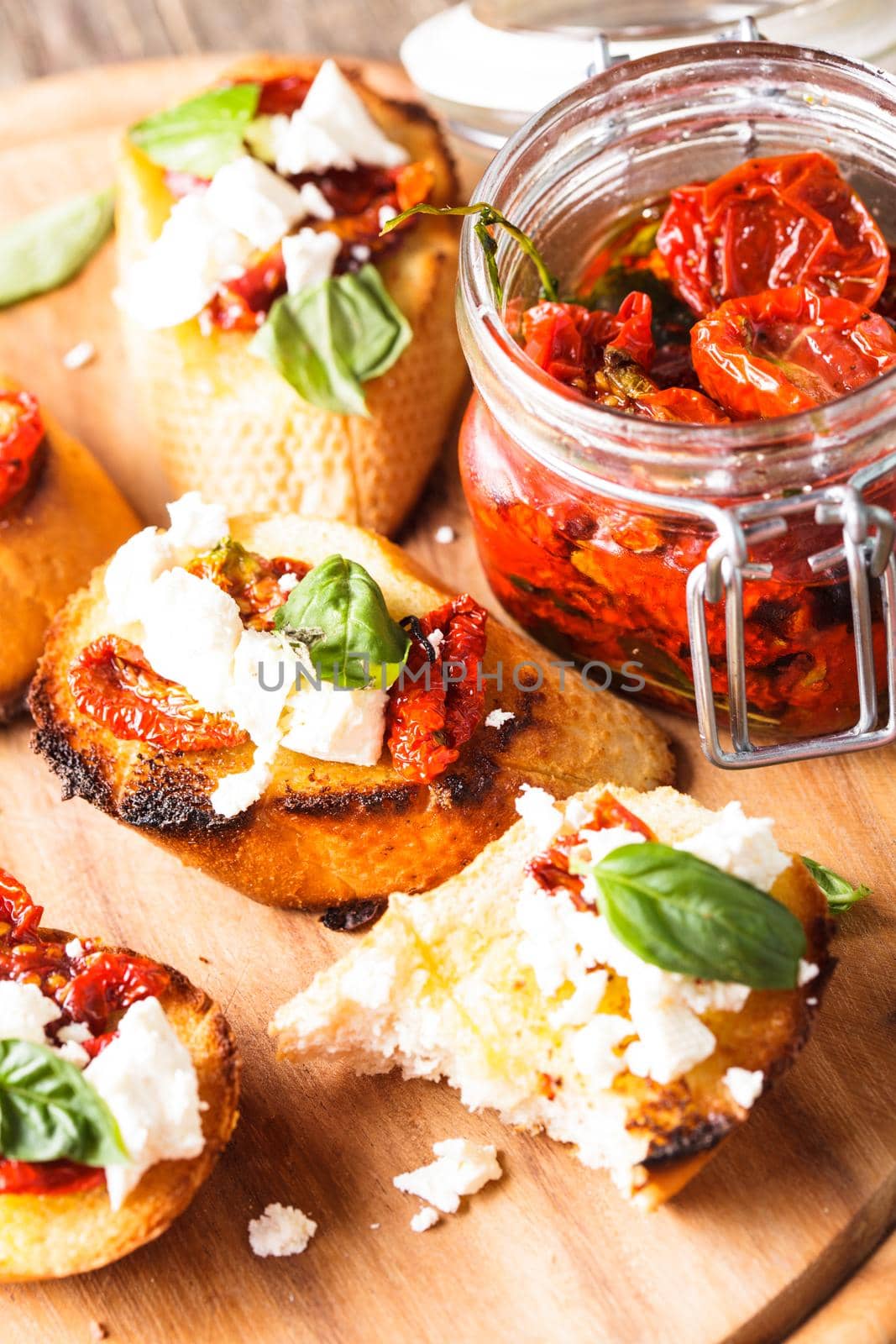 Bruschetta with olive oil, sundried tomatoes, feta and fresh basil