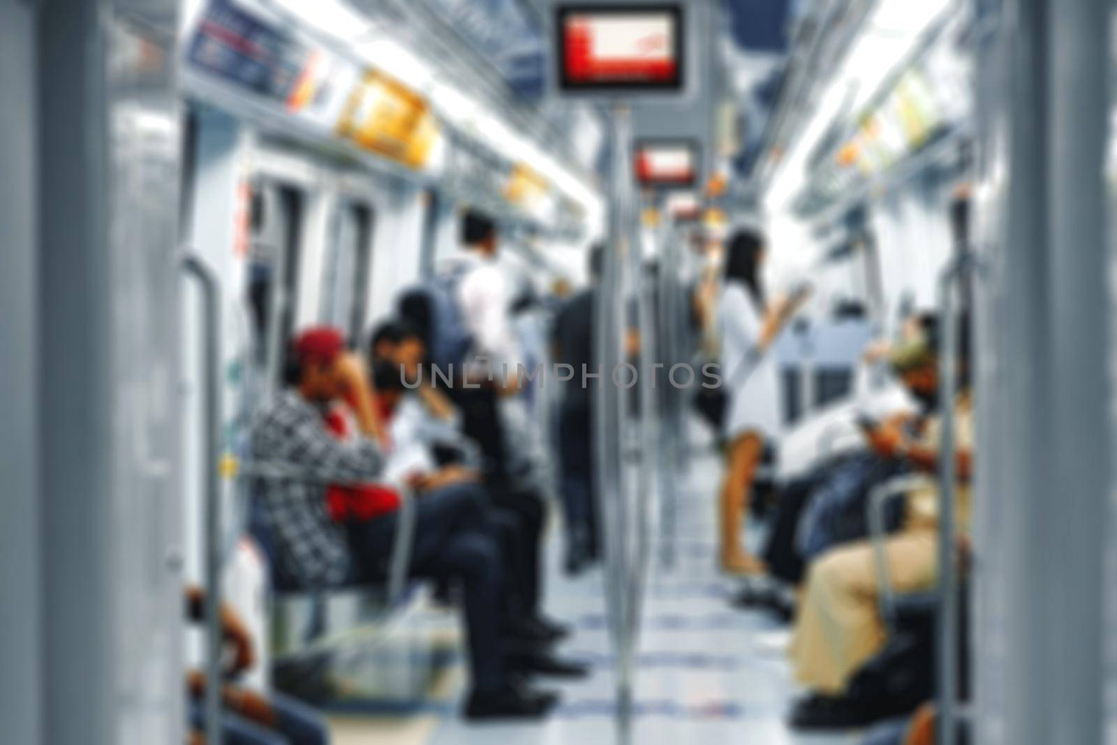 Blurred background of variety of passengers ride the subway car