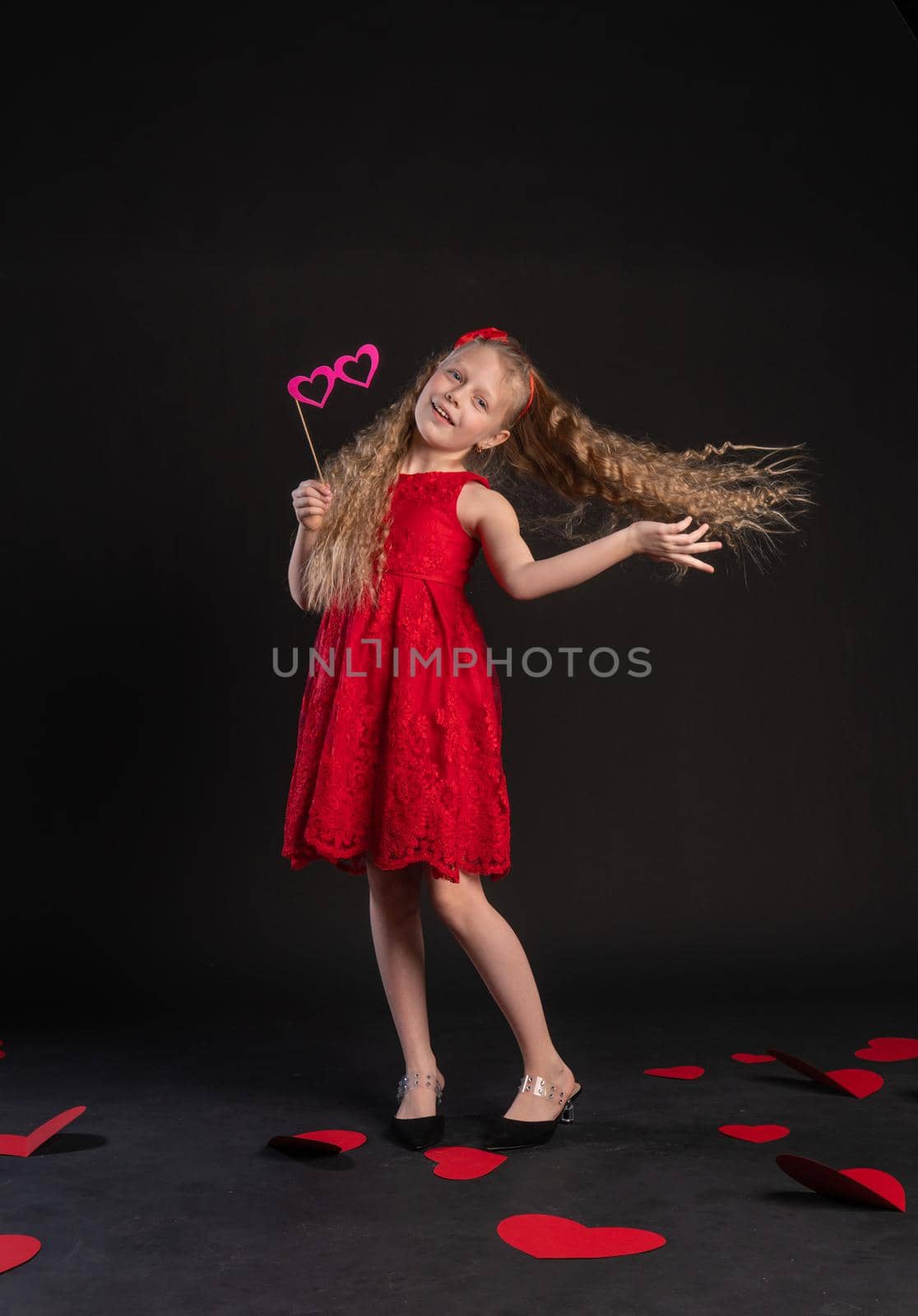 The mask goggles hearts, love, red, Valentine design on the floor of hearts beautiful space. inspiration. emotions, gift in a red dress girl, barefoot by 89167702191