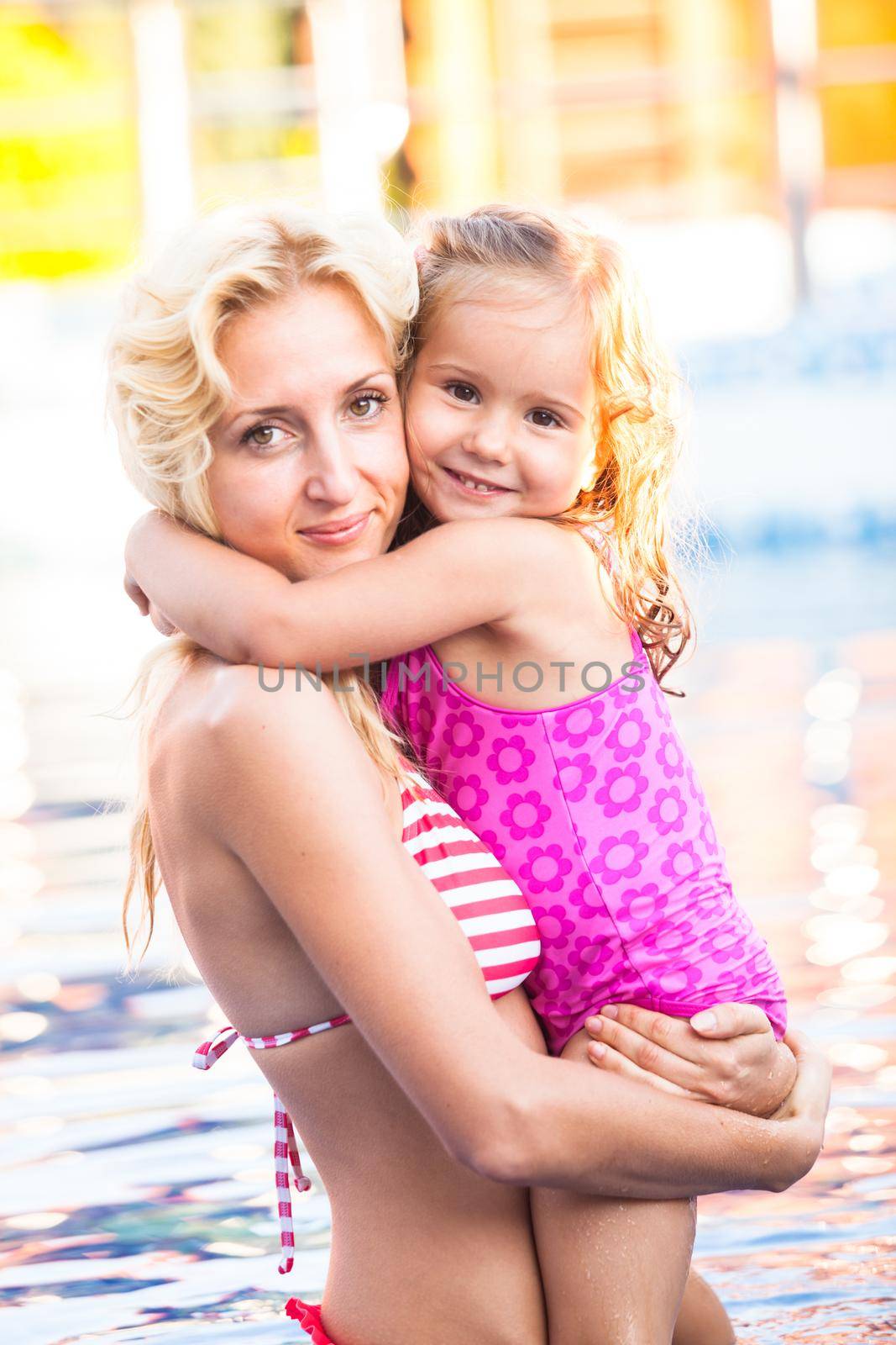 Mother and child at the swimming pool by oksix