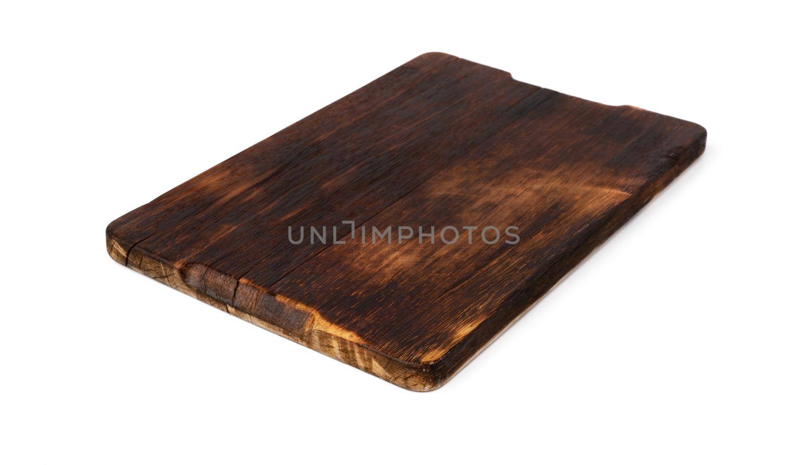 Dark wooden cutting board on white background, close up