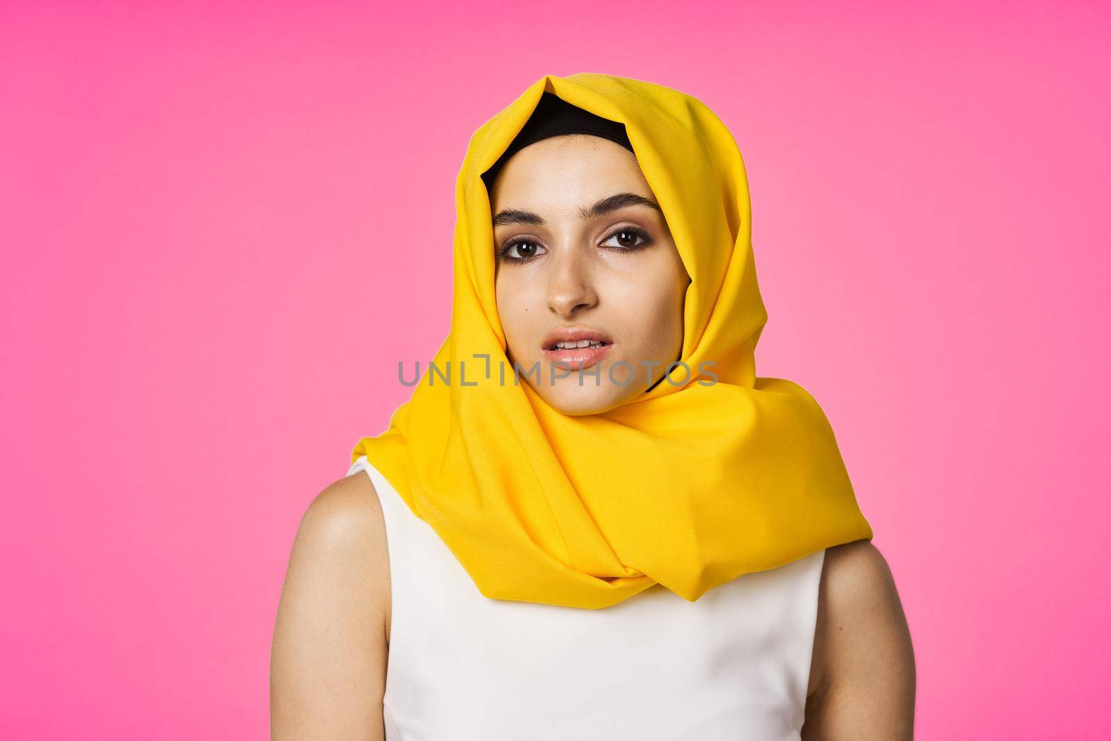 muslim woman in hijab posing fashion ethnicity pink background. High quality photo
