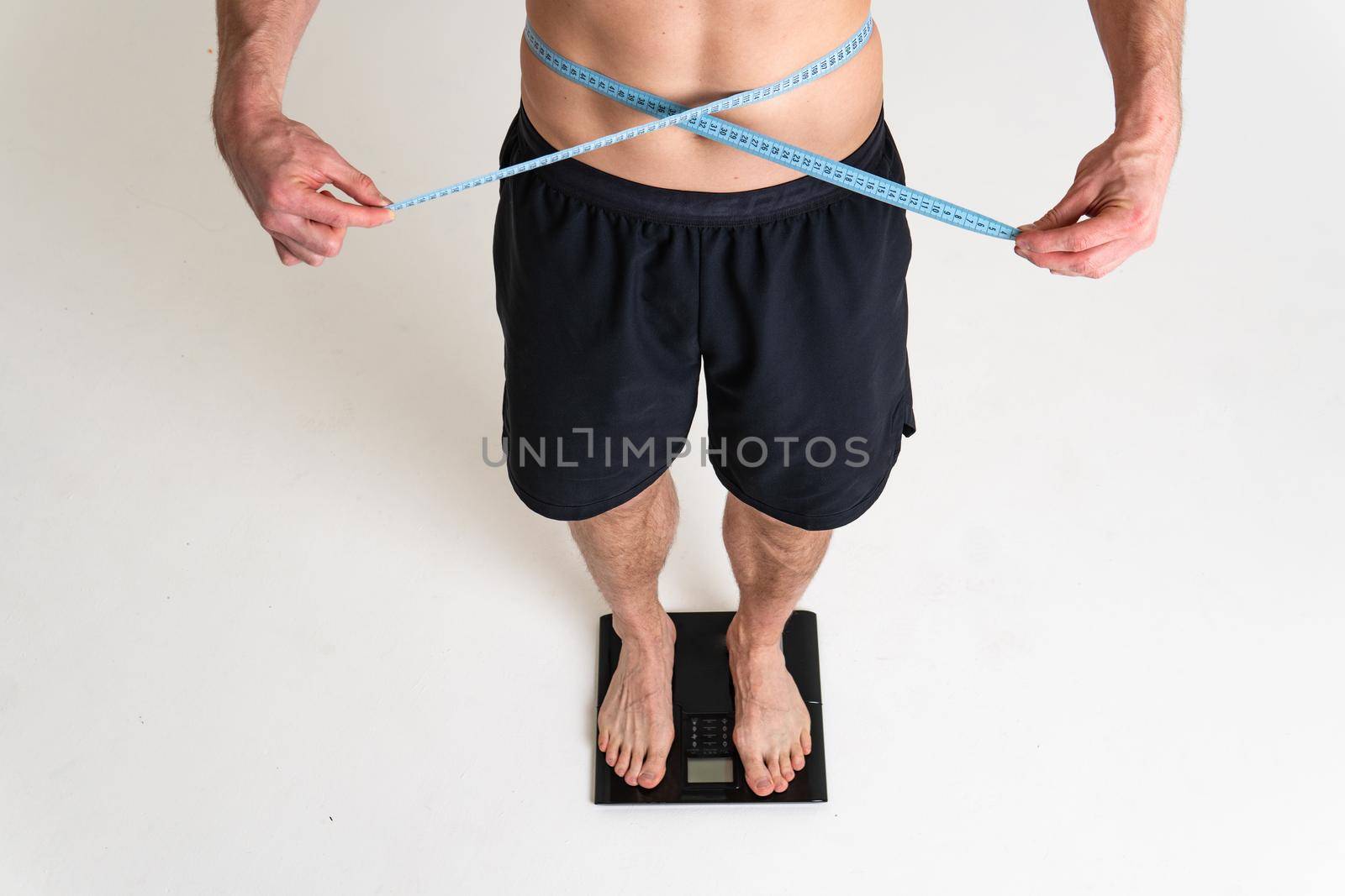 Man with weights health pondered, health and sports on a white background ache body muscle, cramp sick man young medical, hand holding. Touching therapy, lower suffer attractive