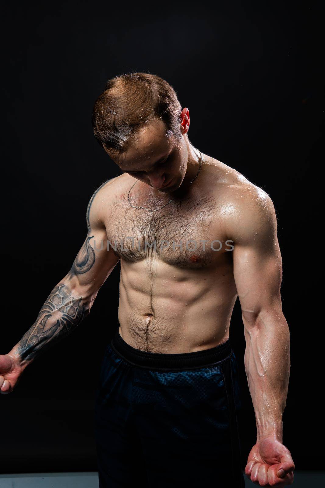 Man on black background keeps dumbbells pumped up in fitness sexy body muscular workout athletic hand, male lifestyle. handsome metal, people fit