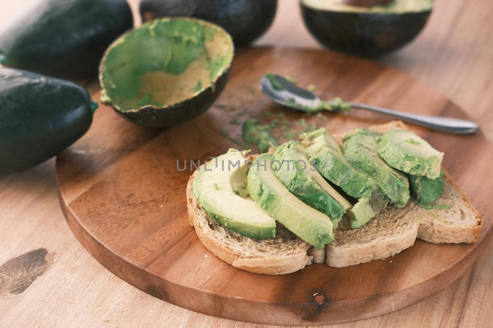 Avocado on slice of a brown bread on table ,