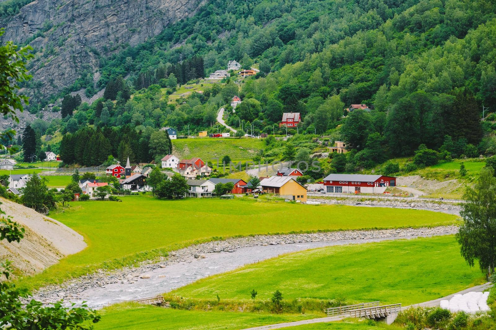 Norway mountain landscape with country houses. Aerial view of the Norwegian village Flam. village of Flam laying on the banks of the river Flam in Norway by Tomashevska