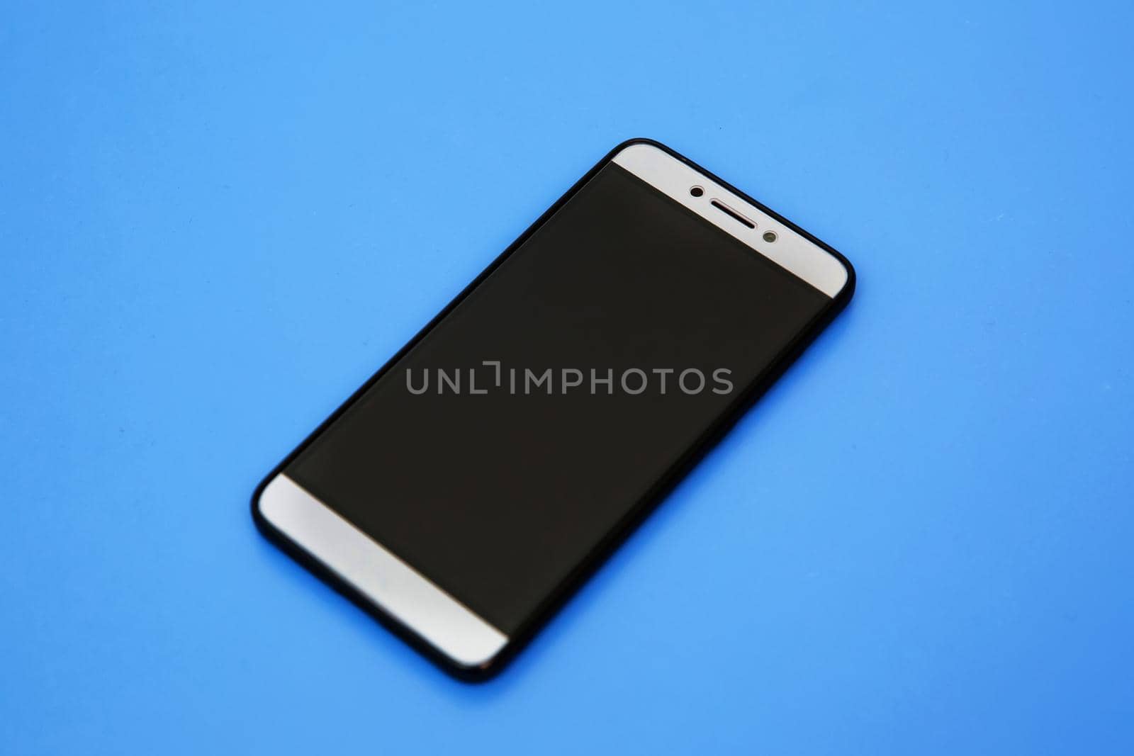Black smartphone mockups. Can use for printing, website, presentation element. for app demo on phone. Empty screen . Black smartphone in blue background, on black screen. Smartphone mock up