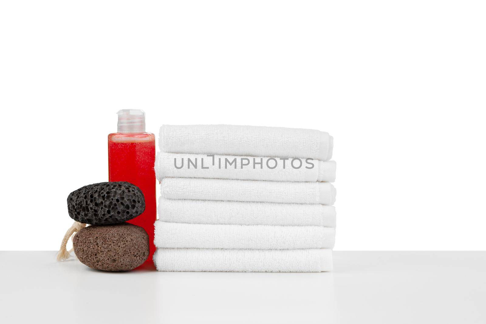 Spa still life with stacked of stone and towel isolated on white background