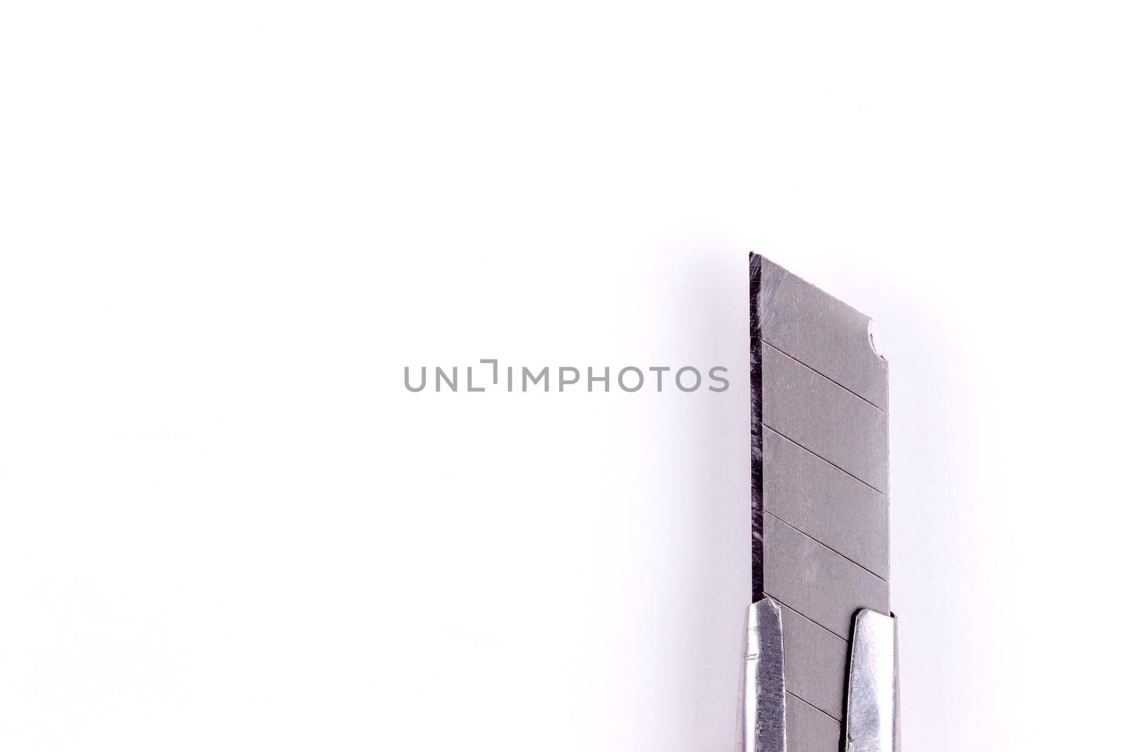 Tip of a stationery knife. Blade close up on a white background isolated.