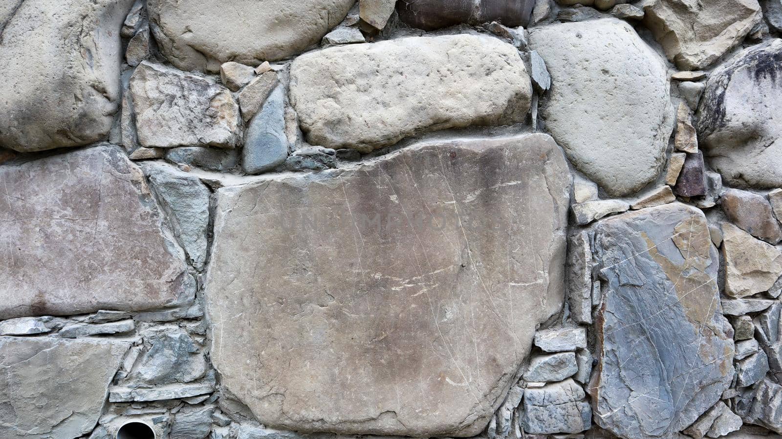 The texture of the stone wall. Old castle stone wall texture background. Stone wall as a background or texture. Part of a stone wall, for background or texture. pattern gray color modern style design.