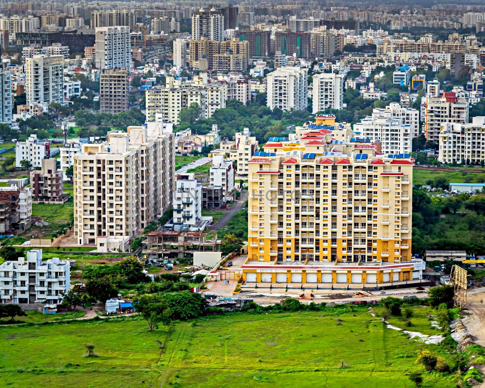 Image of tall buildings under construction near the hill in Pune, Maharashtra.