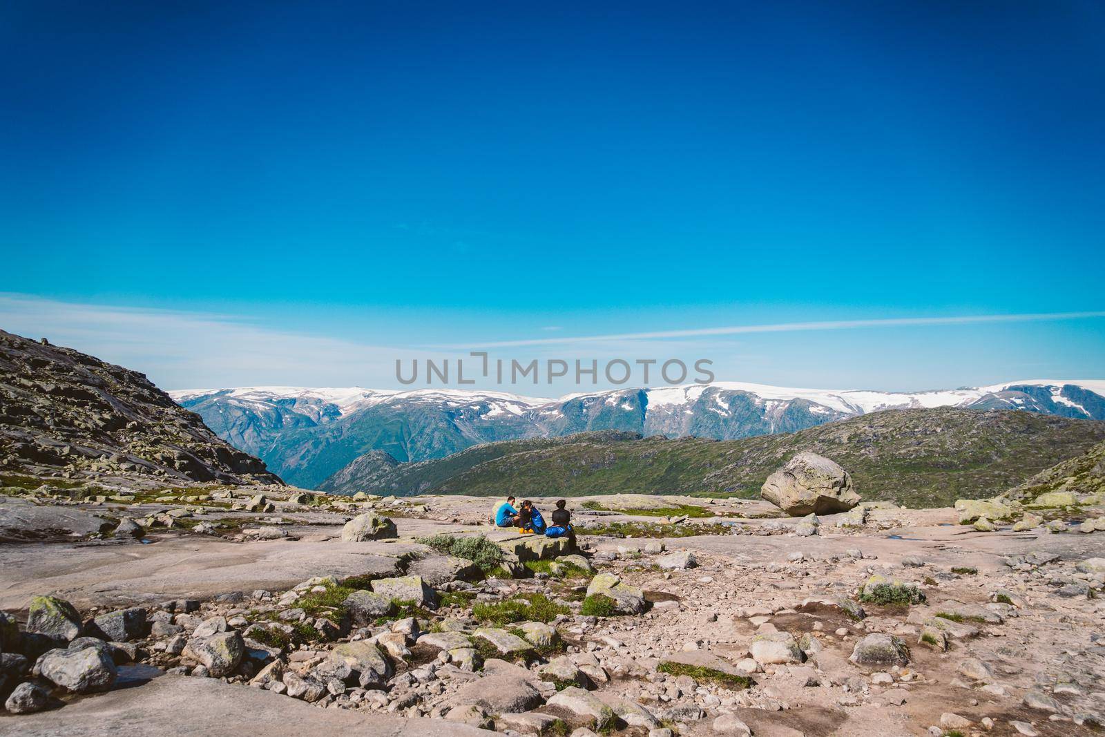 July 26, 2019. Norway tourist route on the trolltunga. People tourists go hiking in the mountains of Norway in fine sunny weather to thetrolltunga. Hiking backpack theme by Tomashevska