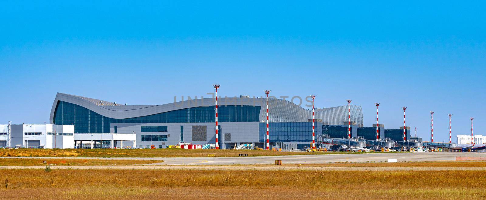 Modern airport terminal building in Russia on sunny day by Fabrikasimf