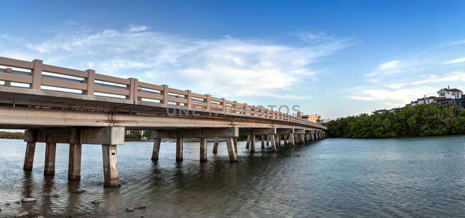 Blue sky over bridge over Hickory Pass leading to the ocean in Bonita Springs by steffstarr