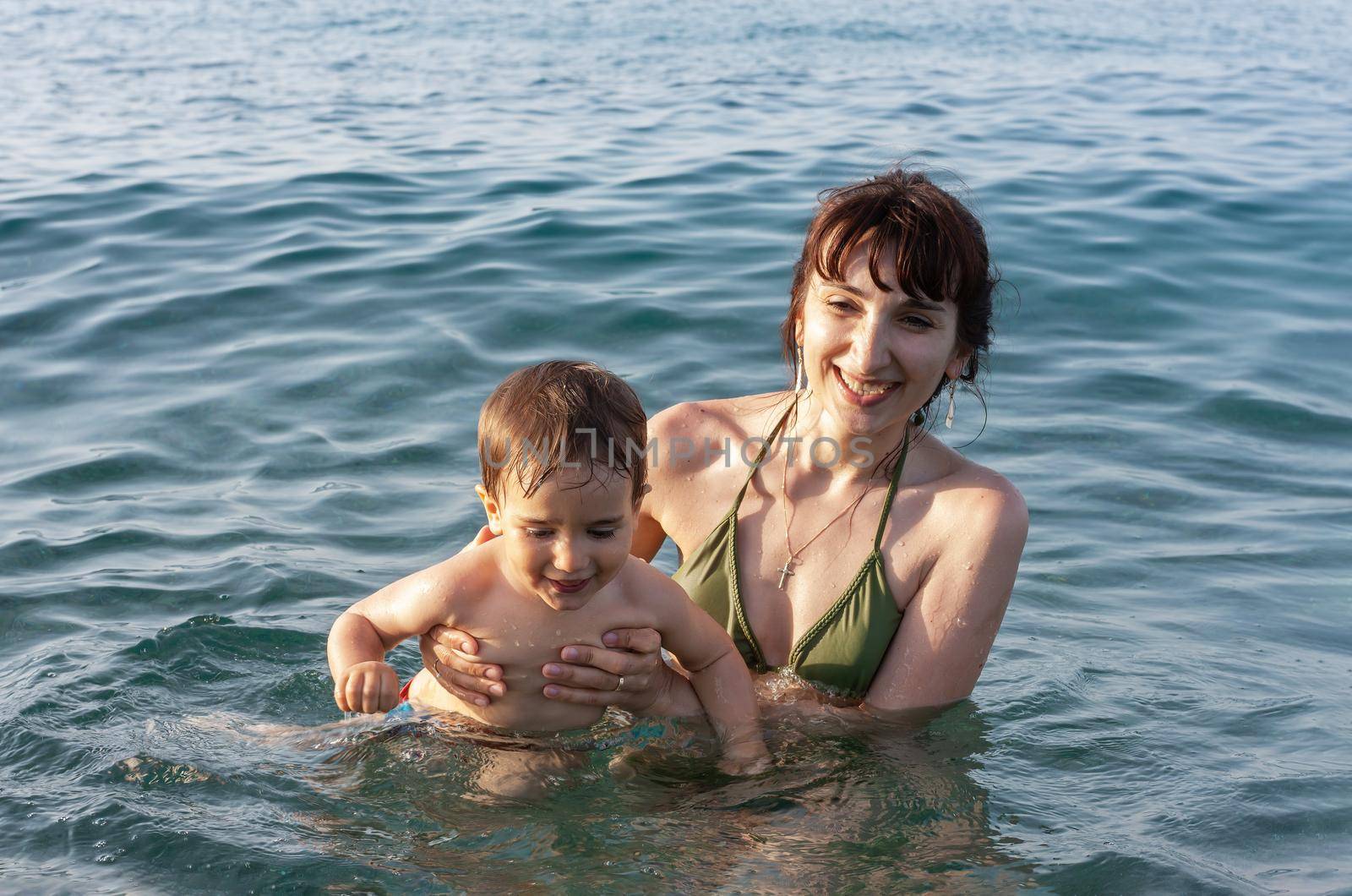 mother and child in the sea by palinchak