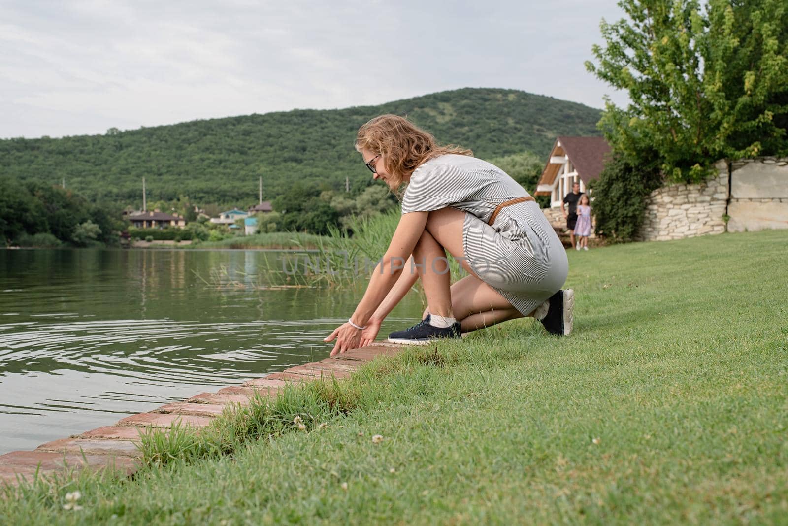 Nature and travel concept. woman sitting near the lake