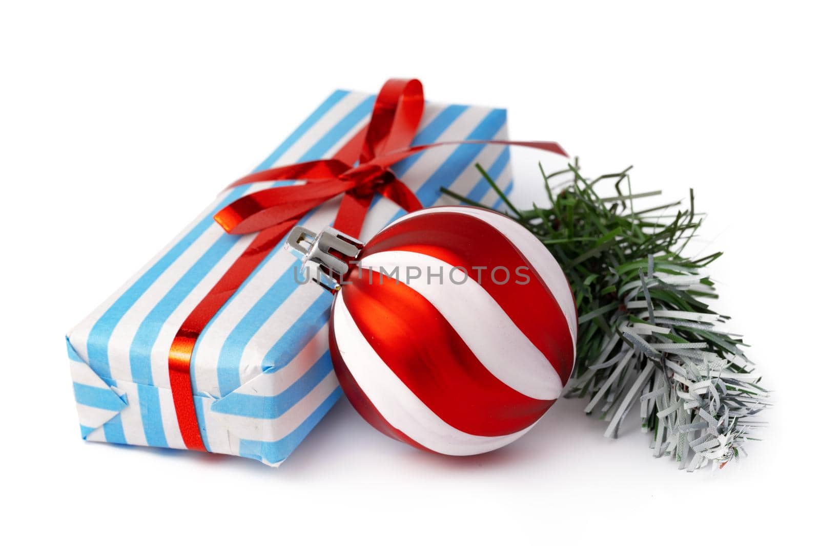 Christmas baubles and festive gift box isolated on white background, close up