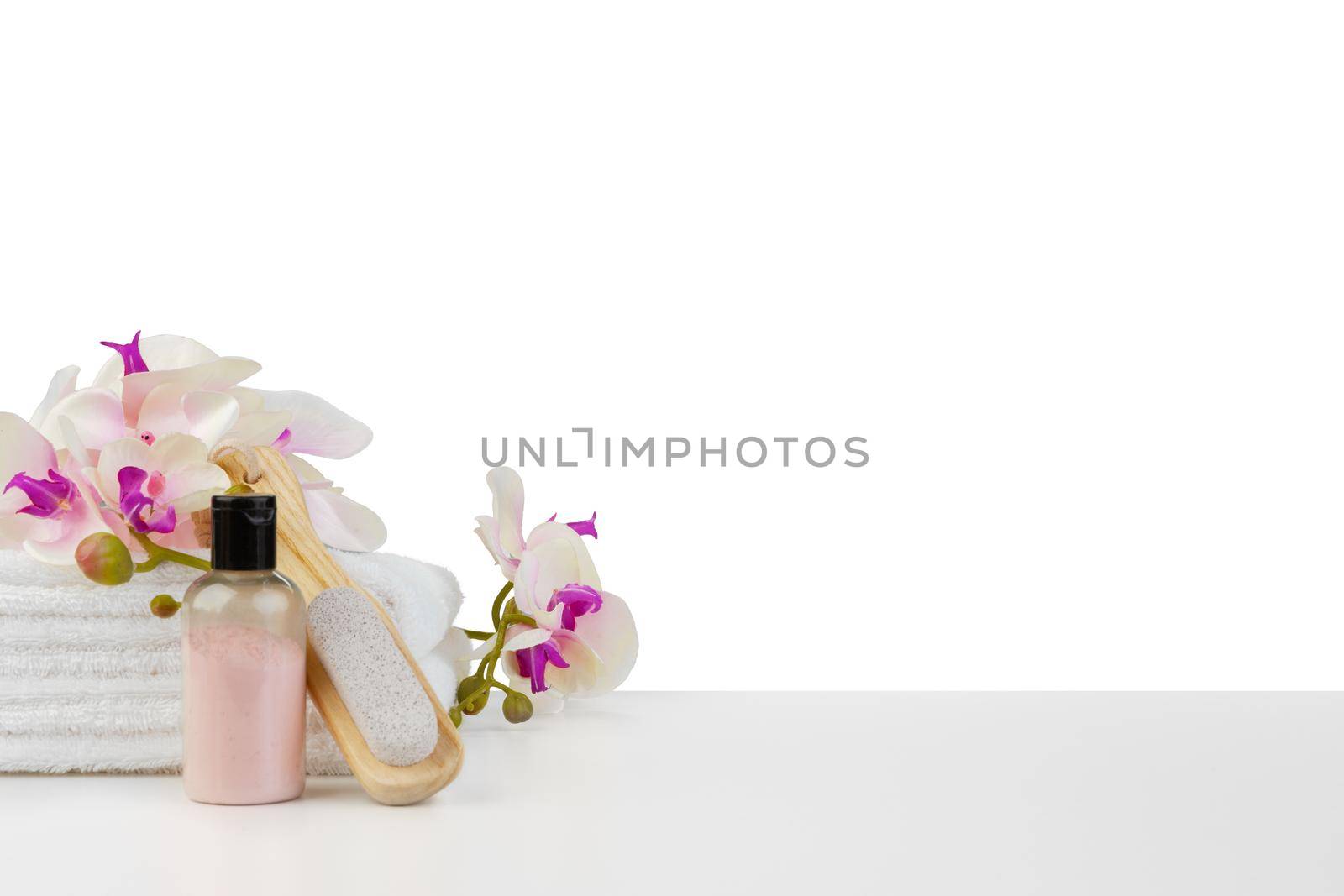 Spa composition with towels and flowers isolated on white by Fabrikasimf