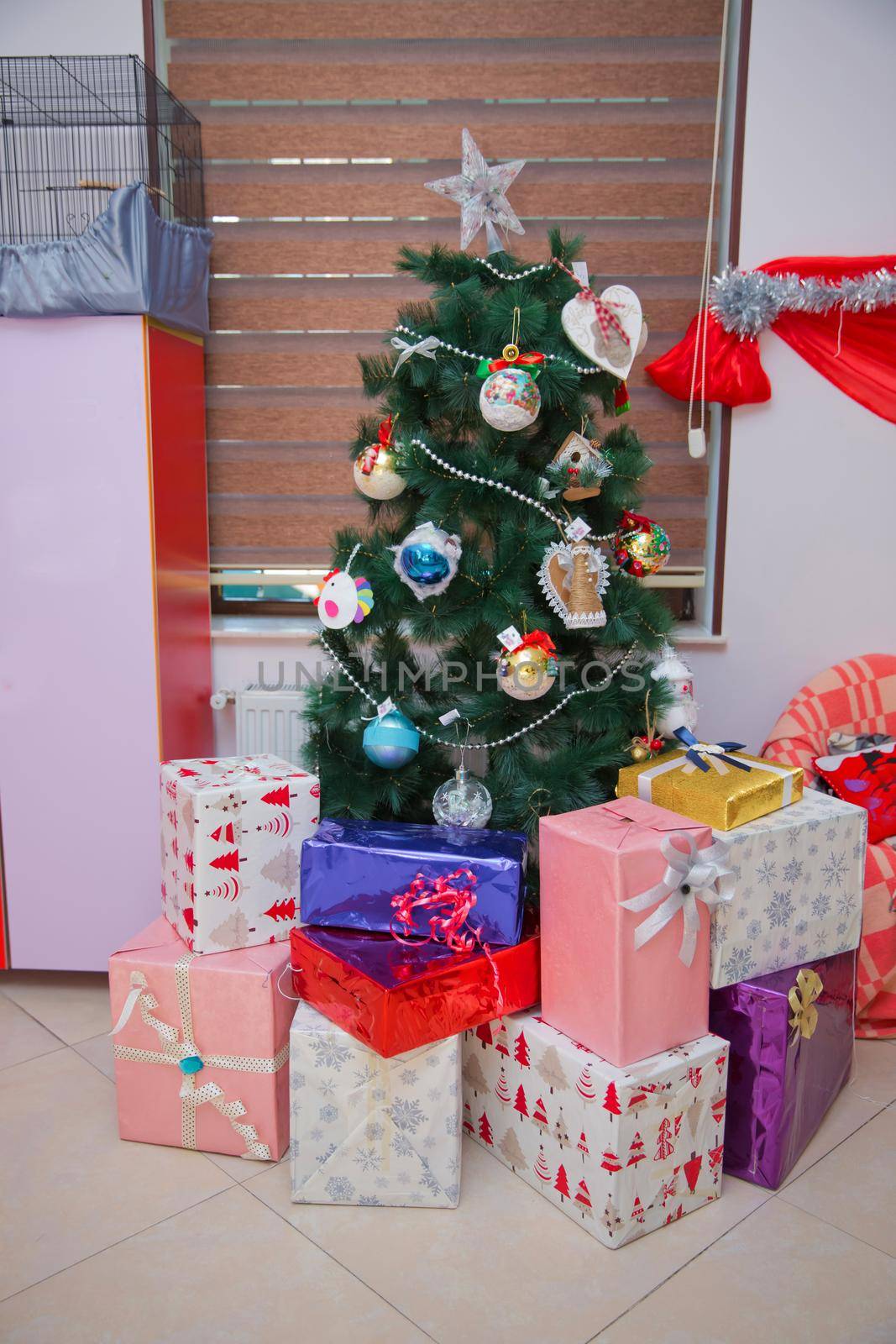 New Year background to take photo . present boxes and decorated christmas tree. gift box for xmas party. new year holiday celebration in december