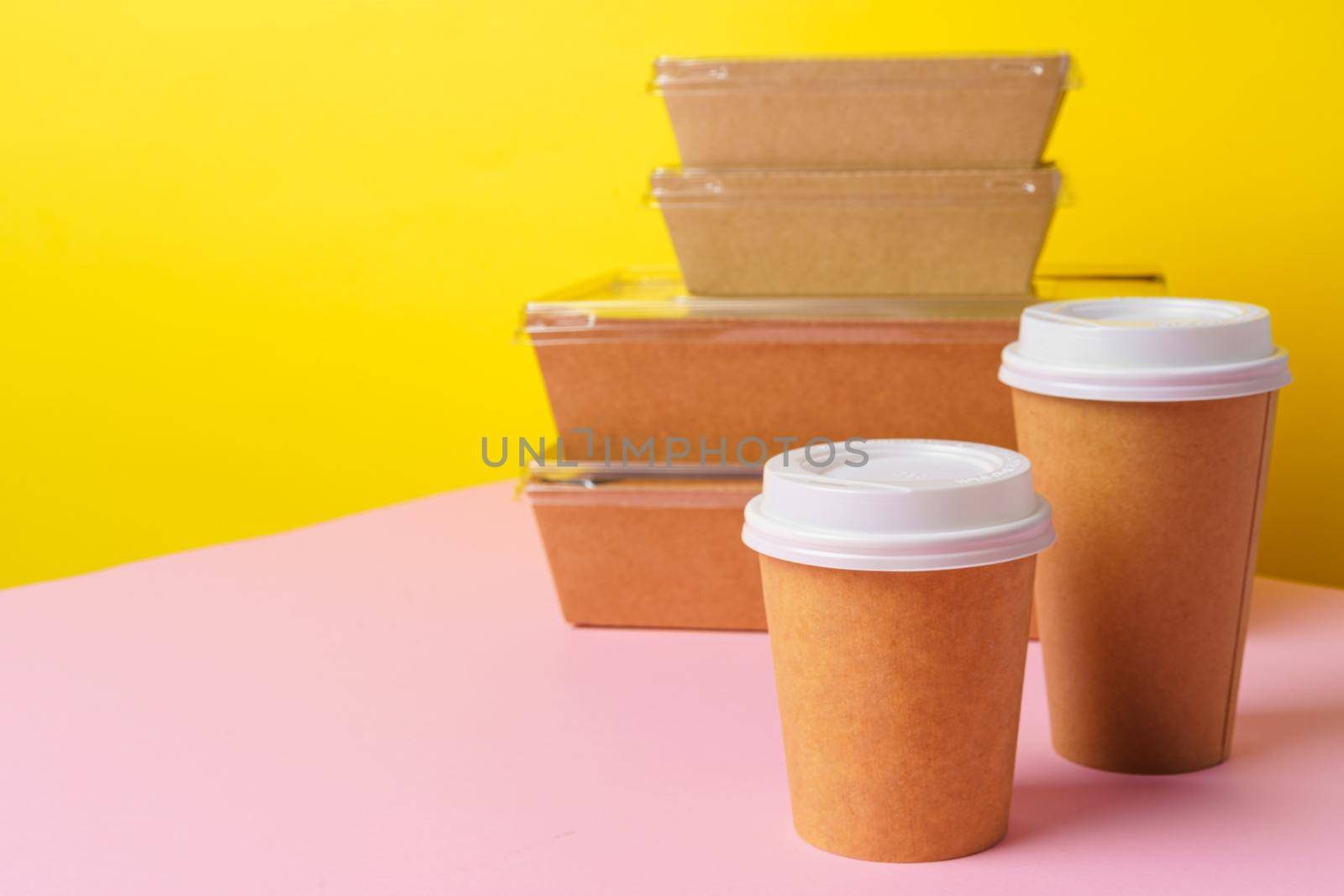 Takeaway food concept. Some packed food in container with coffee cup on table
