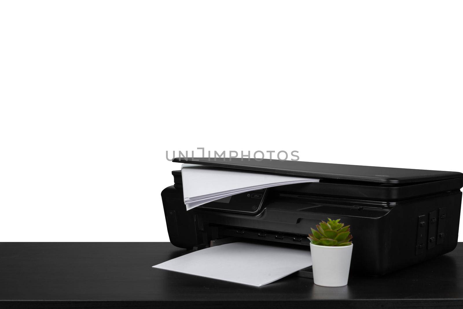 Laser home printer on table against white background, close up