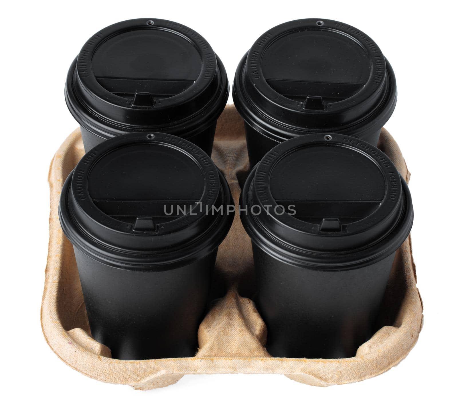 Four takeaway coffee cups in a tray isolated on white background