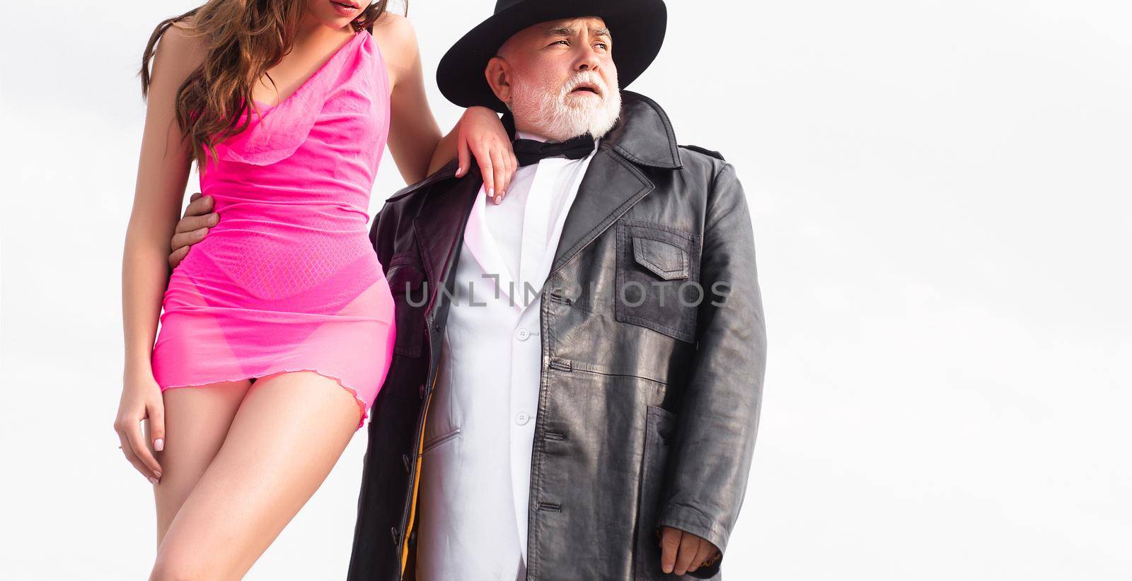 Senior old man and sexy young woman