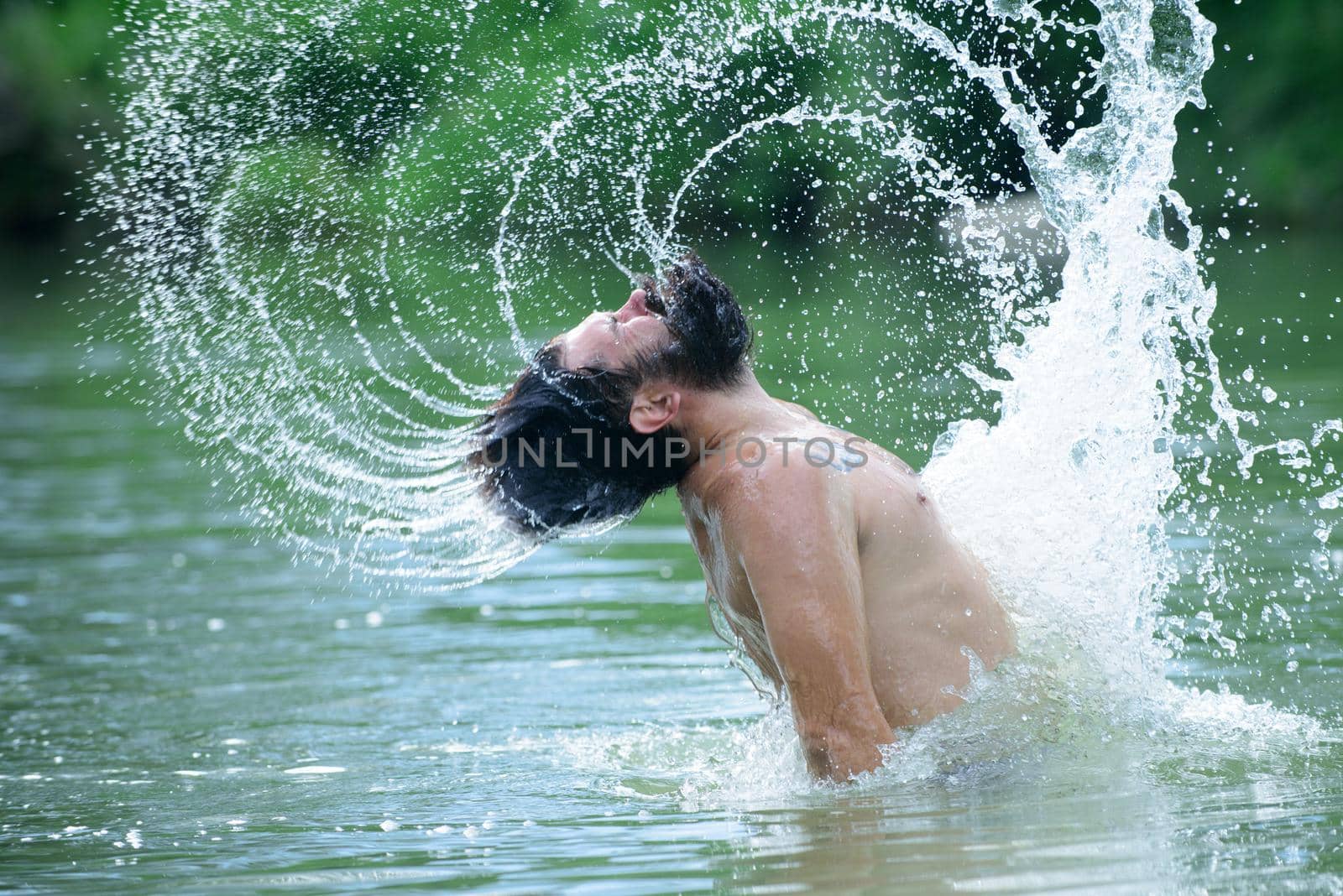 Funny summer man splash water droplets in long beard