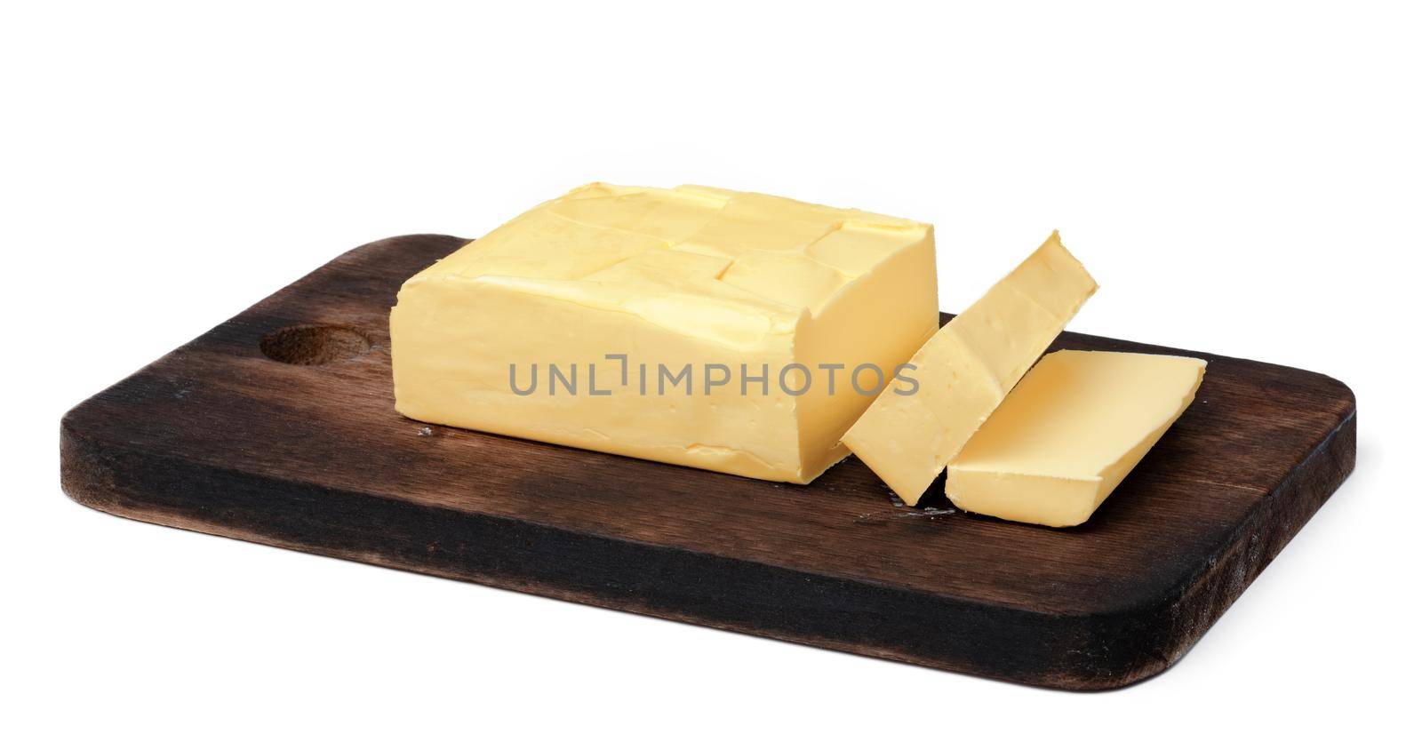 Butter on wooden board isolated on white background, close up