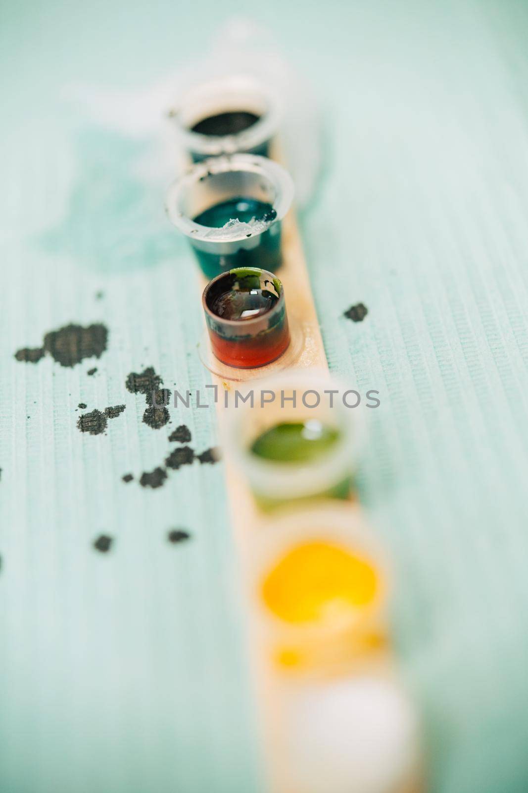 Little tattoo ink bottles full of different colors. by javiindy