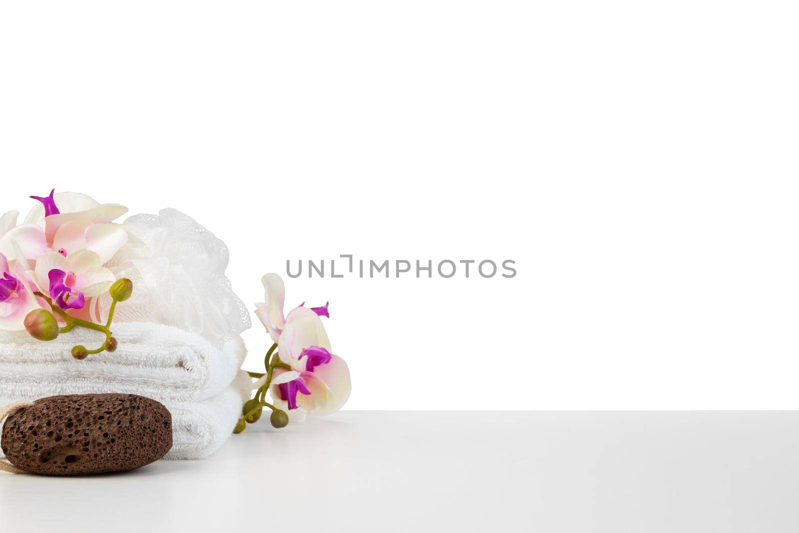 Spa composition with towels and flowers isolated on white by Fabrikasimf
