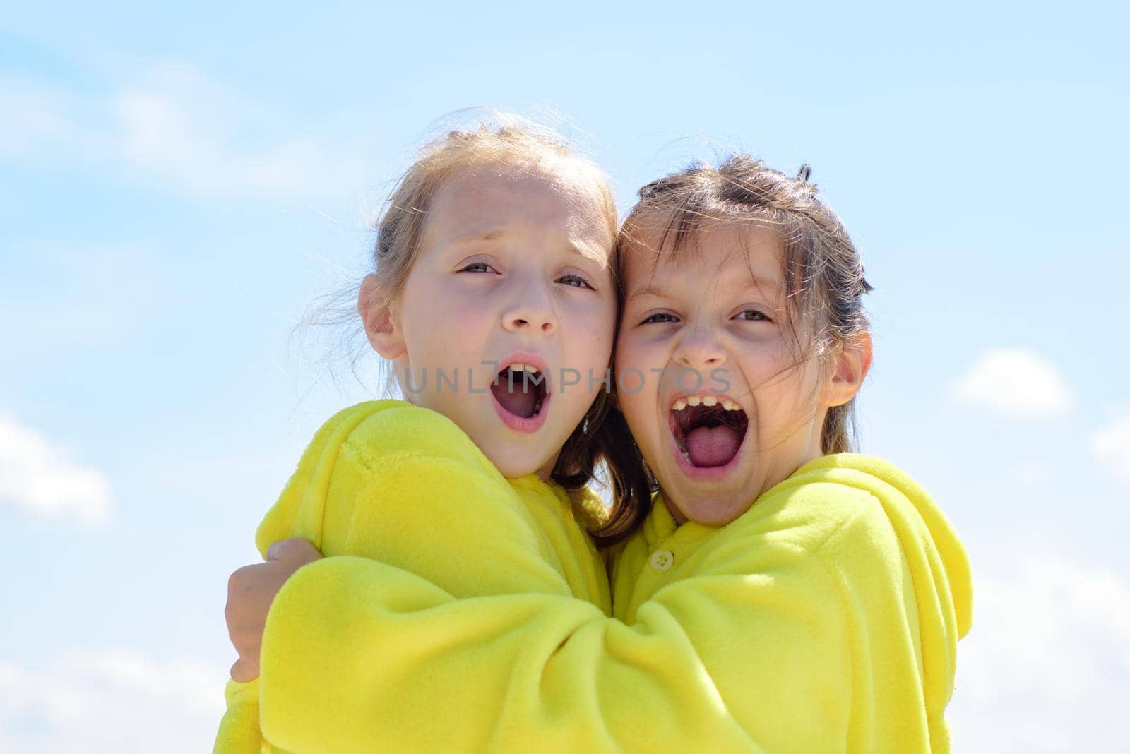 Funny kids face of two cute little children embrace. Funny lovely kids hug. Girlish leisure. by Tverdokhlib