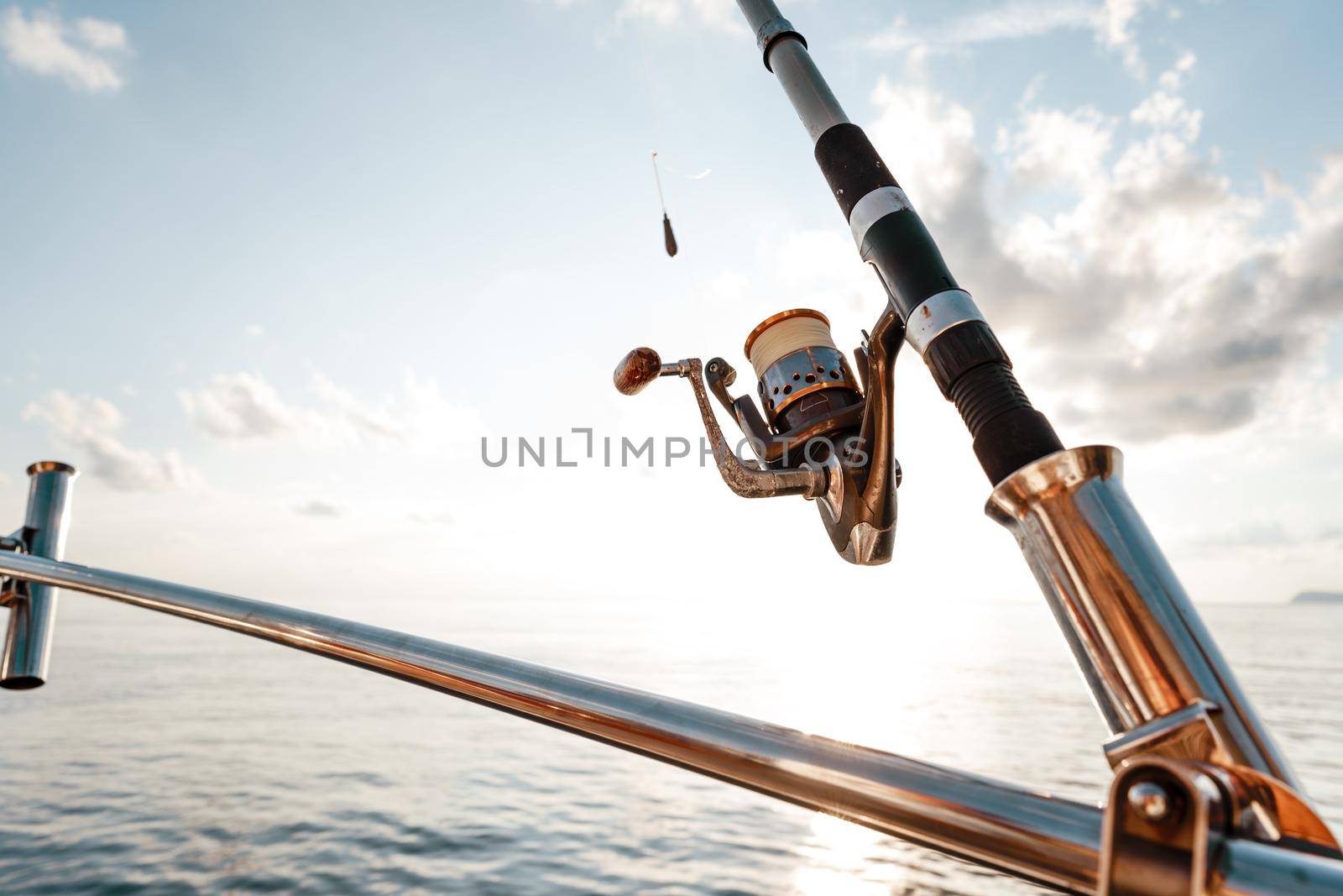Fishing rod on a sailboat on the background of the open sea