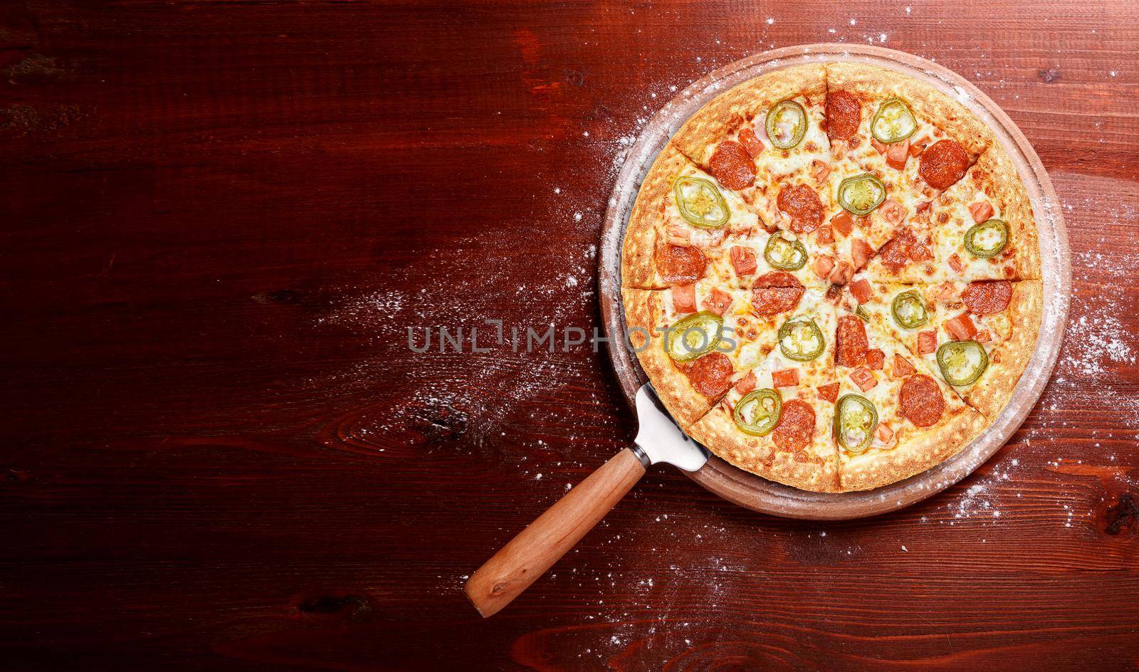 fresh american pizza on wooden table with space for text