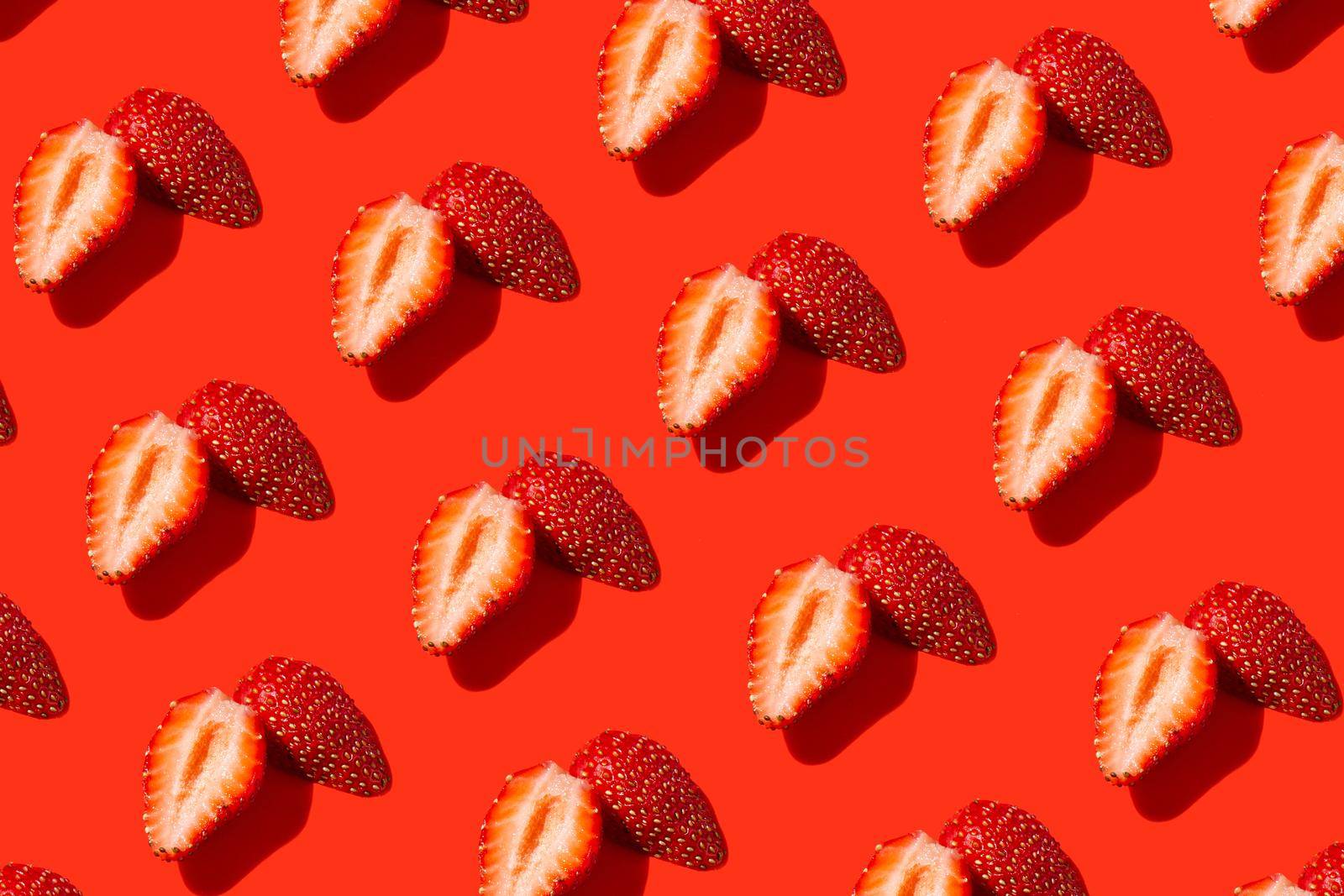 decorative pattern red strawberry berry cut into pieces on red background by Marina-A