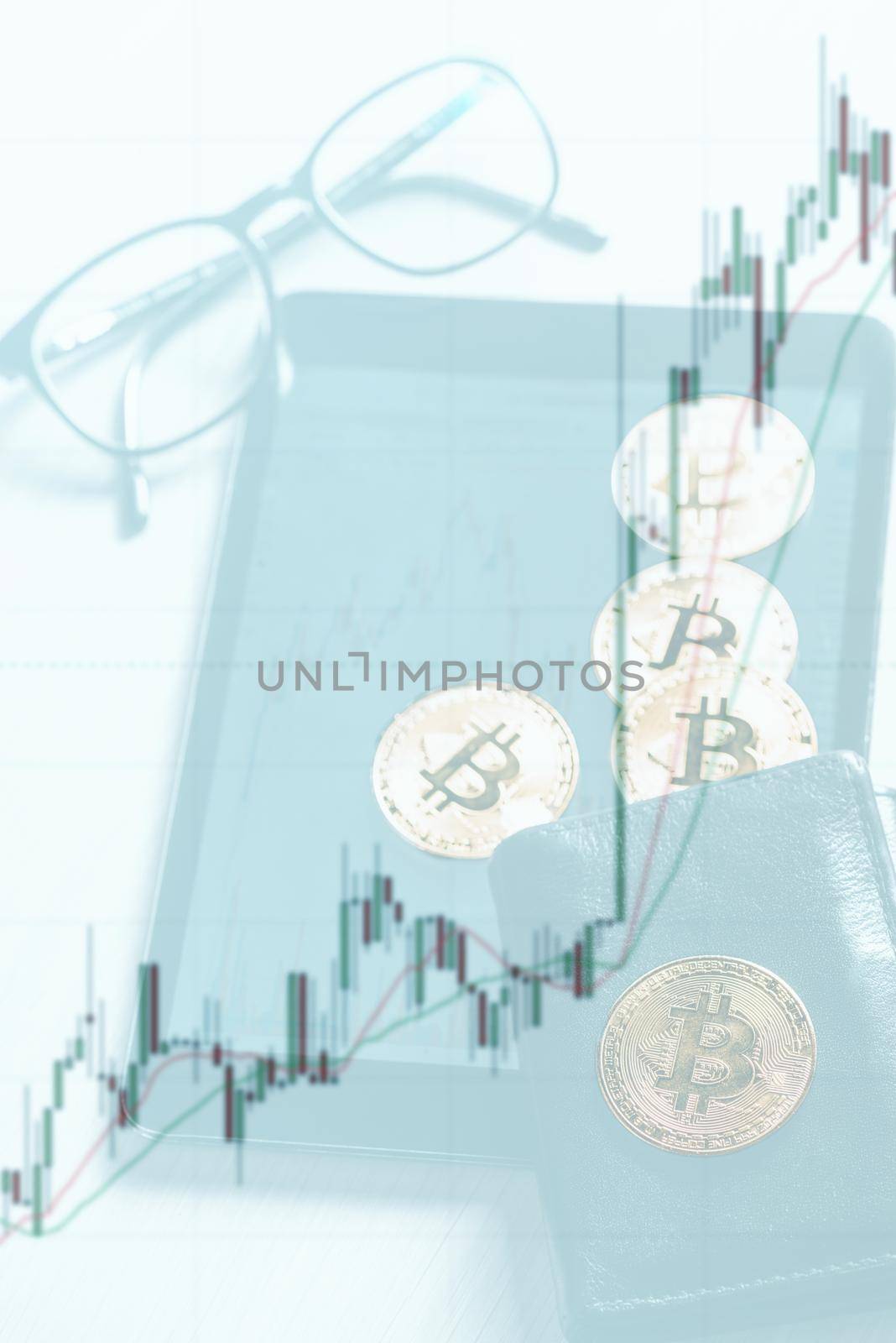 Double exposure of growth diagram with image of gold bitcoins on wallet and digital tablet near the glasses.