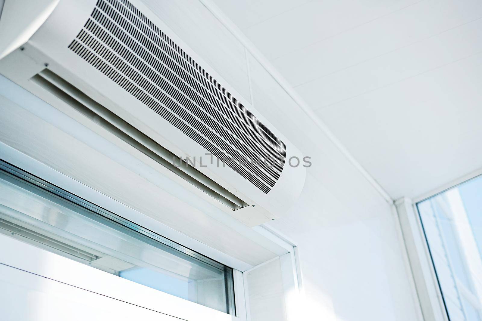 Large household air conditioning in a bright room. Device for adjusting the indoor climate. Copy space by SergeyPakulin