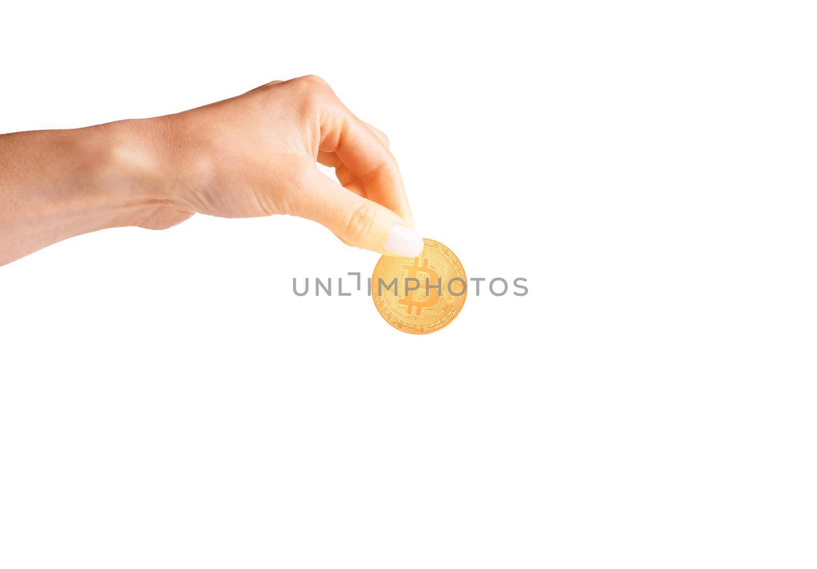 Woman’s hand holding glowing gold bitcoin on a white background, copy-space.