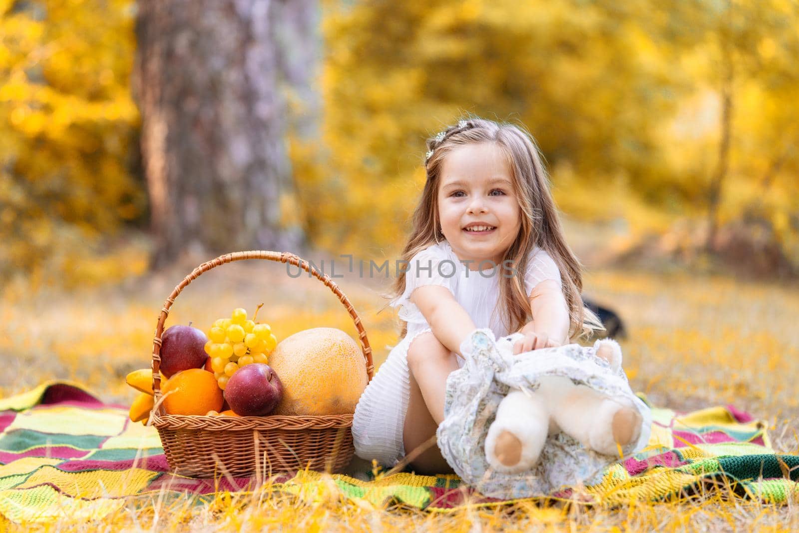 Happy little children in the garden on leaves falling fall background
