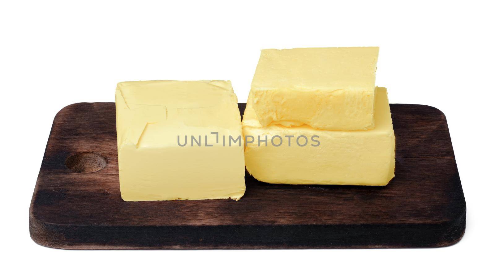 Butter on wooden board isolated on white background by Fabrikasimf